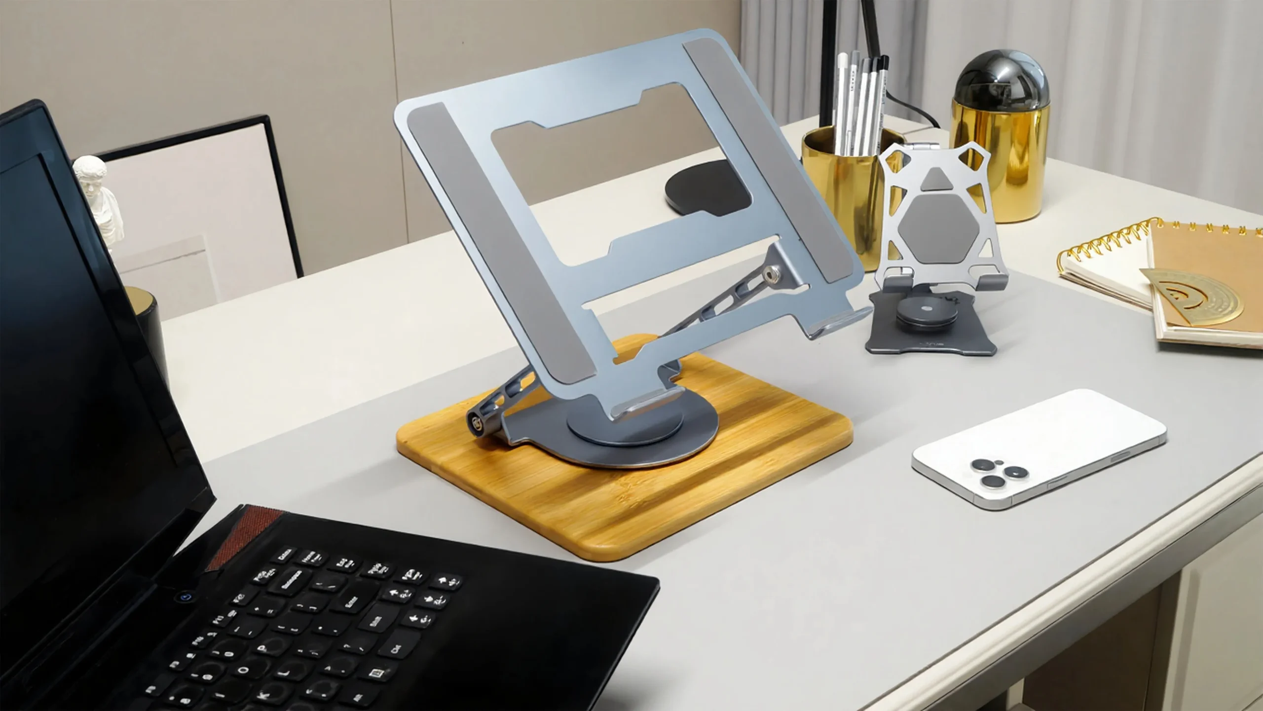 Grey laptop stand on the desktop.